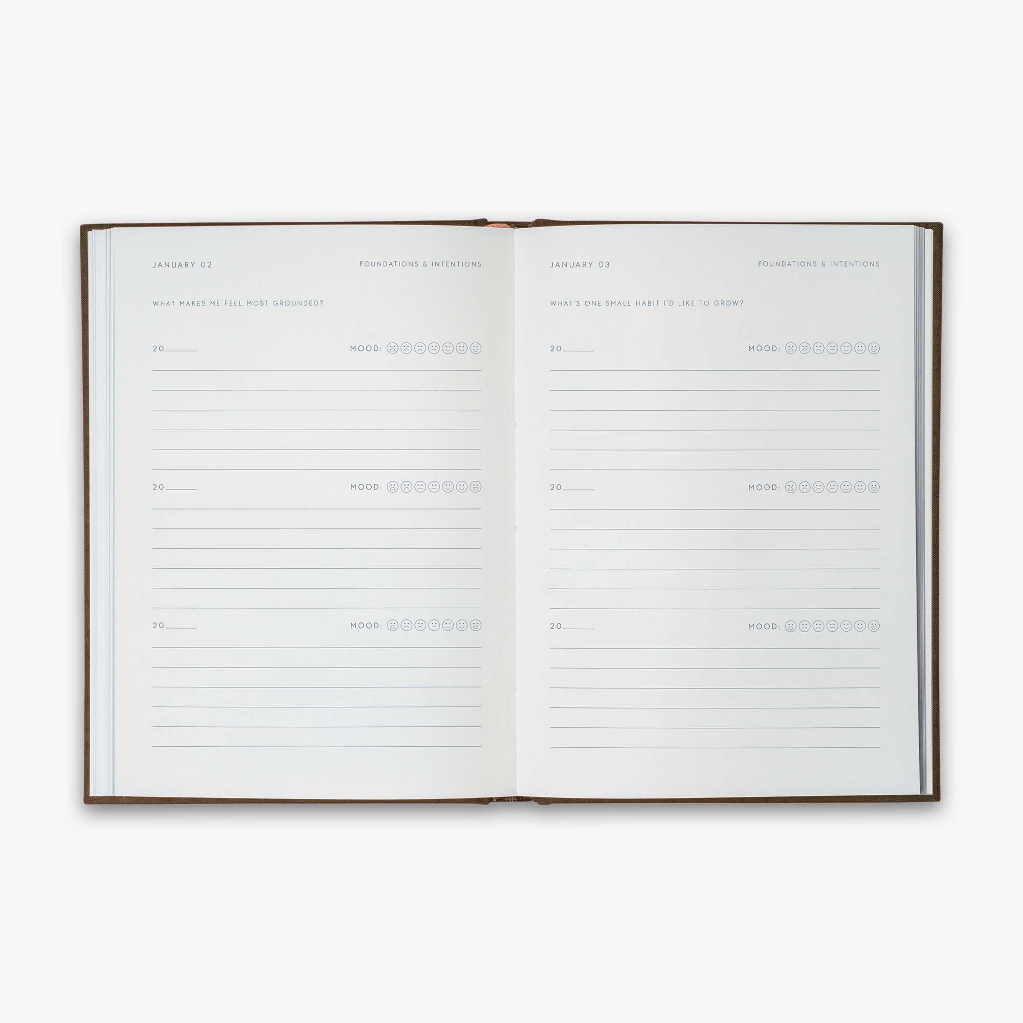 Open book from our Three Year Journal with the daily prompts on a white background