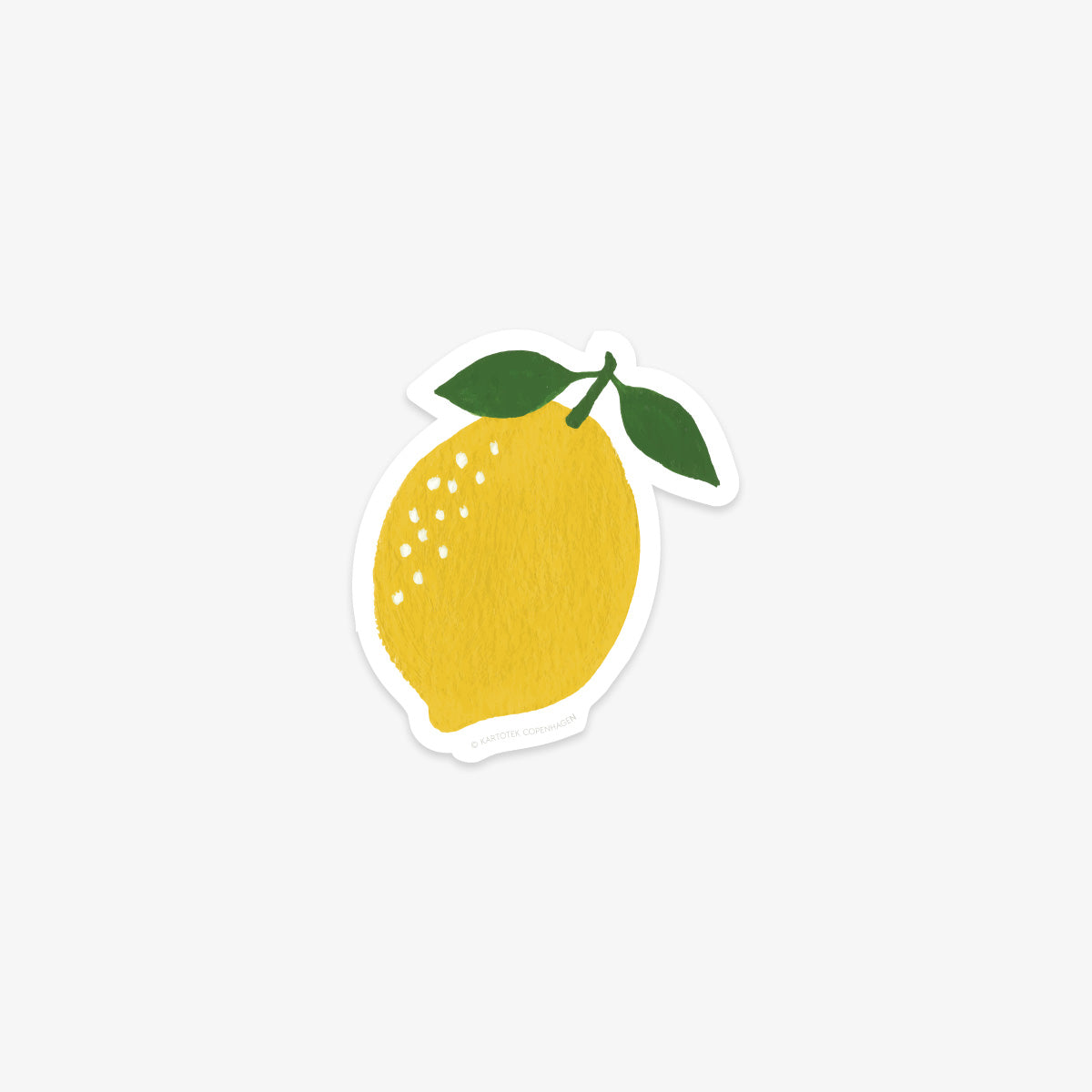 Vinyl sticker of a yellow lemon with green leaves on a white background