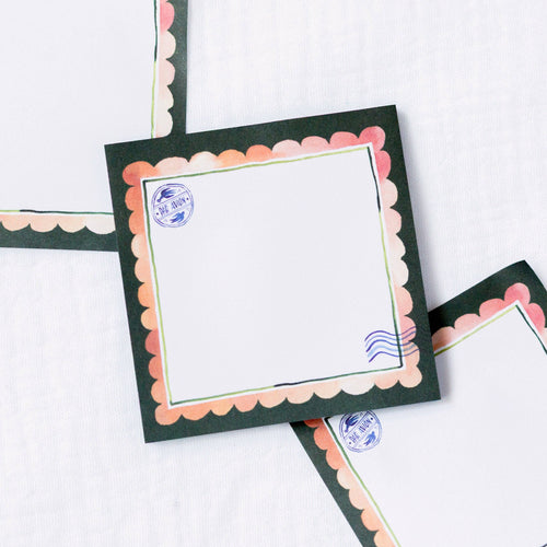 Decorative sticky notes with scalloped edges and postage stamp designs on a white background