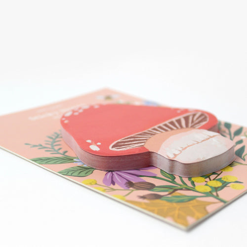 Mushroom-shaped sticky notes on a floral design on a white background