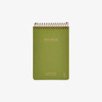 Green notebook with spiral binding on a white background