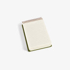Small spiral-bound notebook with lined pages on a white background