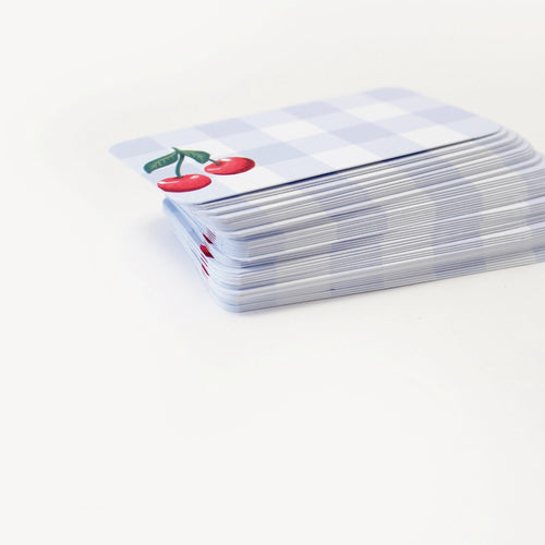 Stack of playing cards with a cherry design on a white background