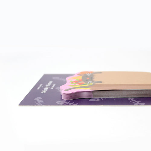 Stack of colorful grocery-kitten-shaped sticky notes on a white background