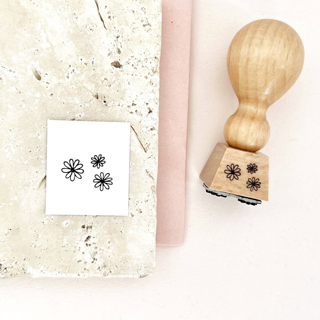 Wooden stamp with floral designs on a white surface