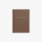 Brown guided journal titled 'Three Year Journal' on a white background