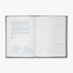 Open book from our Three Year Journal (Treårsdagbogen) with short description of the purpose of the book and the daily prompts on a white background