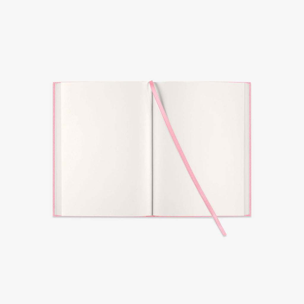 Open book with pink ribbon on a white background