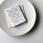 Notebook with checkered cover on a white plate