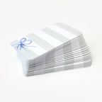 Stack of pocket cards with a blue bow on a white background