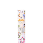 A single roll of Nectar Meadows gift wrap standing upright on a plain white background. The packaging label features a white base with vertical orange stripes and a delicate floral border in pink, blue, yellow, and green.