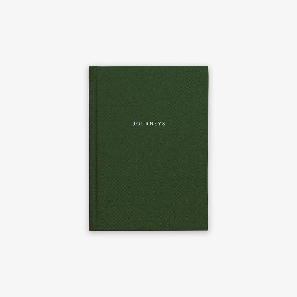 A green, hardcover cloth-bound notebook with the word 'JOURNEYS' printed on the cover in capital letters.